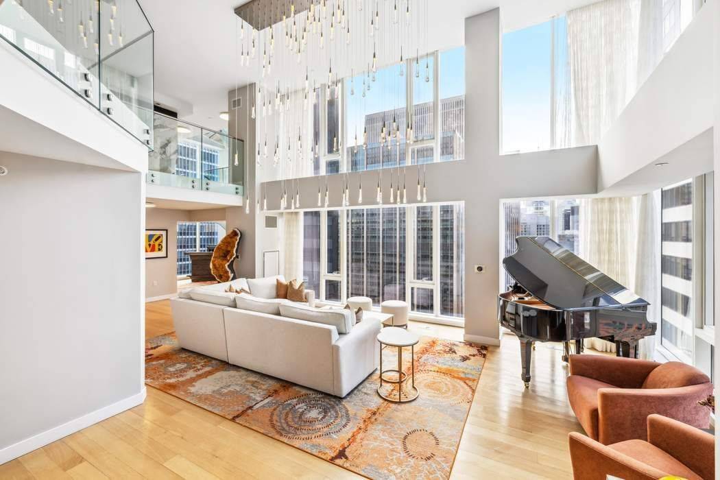 Soaring above Midtown Manhattan and commanding the top three floors of 135 West 52nd Street, this one of a kind triplex penthouse is an architectural showpiece.