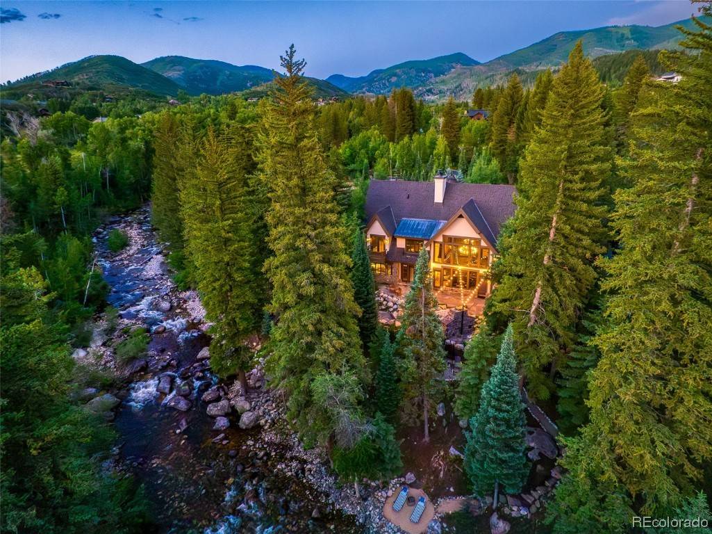 Welcome to this spectacular, European ski chalet with a truly grand entry into the great room, looking beyond to the patio and creek.