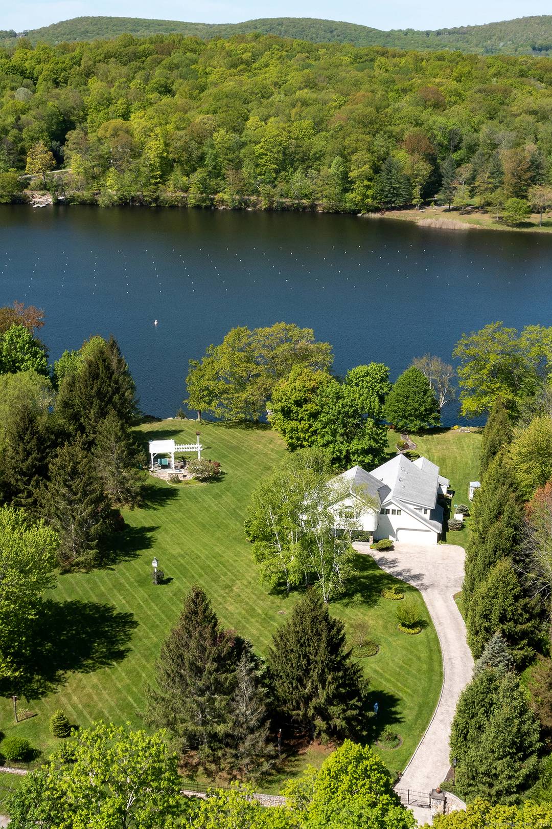 Rare Direct Waterfront Lake Waramaug 5 bedroom 3 full 2 half bathroom home with stunning western views on beautifully maintained double lot.