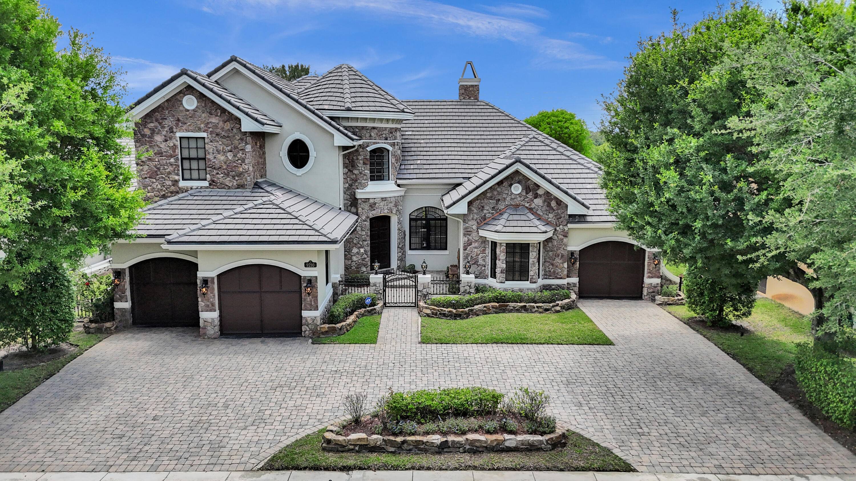 Nestled within the prestigious Equus community in Boynton Beach, this exceptional 4 bedroom, 5.