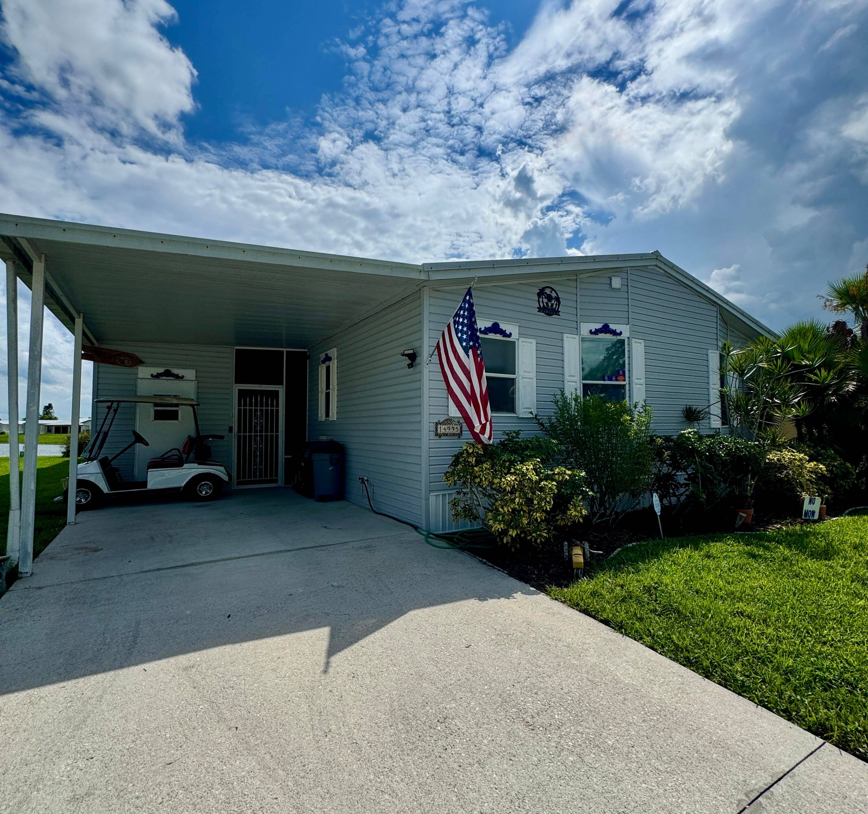 This lovely triple wide 2 bedroom 2 bath home is in the desirable 55 Spanish Lakes Fairways community.