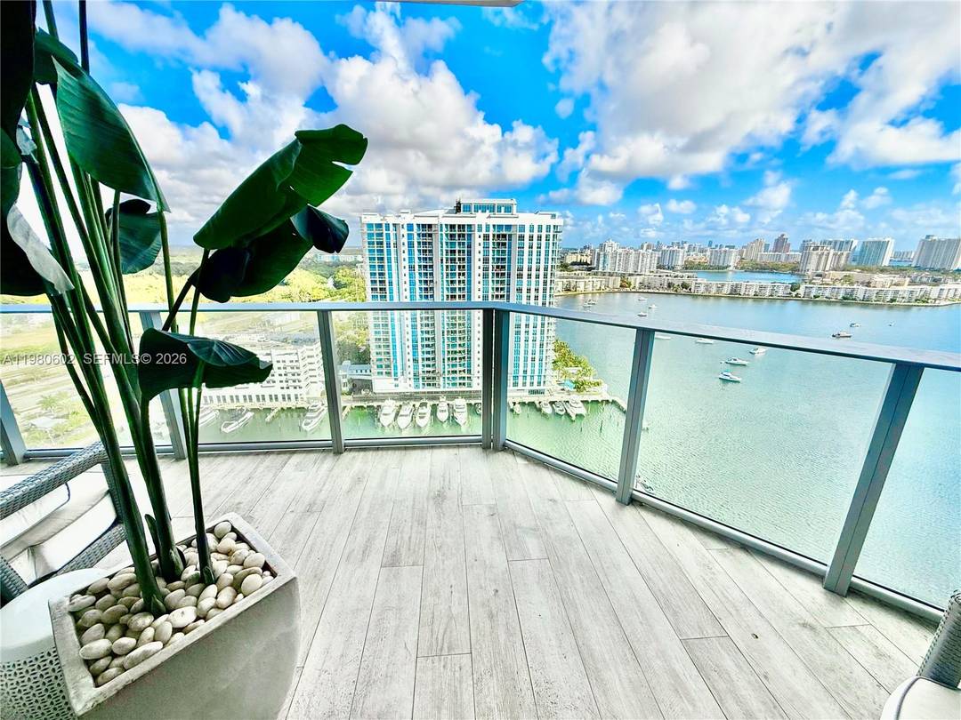 Luxurious turnkey high floor residence on the 23rd floor at The Reserve at Marina Palms with stunning unobstructed water and city views.