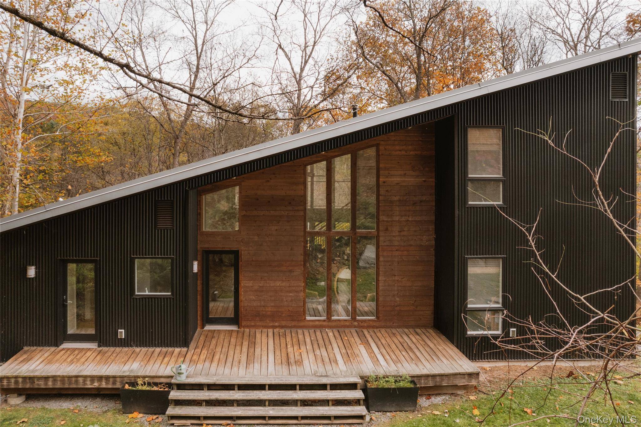 An open floor plan combines the modern kitchen, with high end appliances and an oversized island, a dining nook surrounded by windows for canopy views and living room with cozy ...