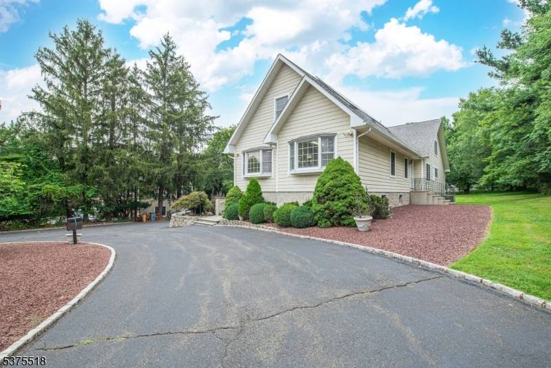 This unique expanded ranch is set back from the road on an oversized lot w a stately circular driveway offering privacy grand curb appeal.