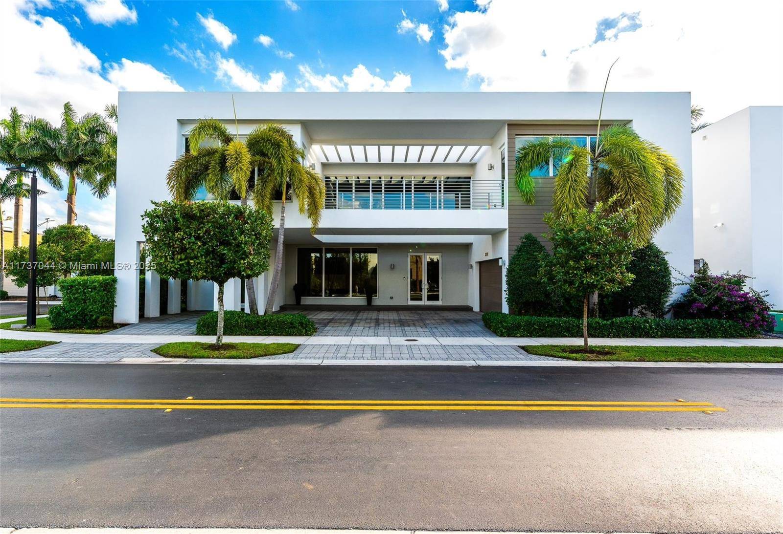 Step into elegance with this stunning corner lot estate, the largest model in the exclusive gated community of Modern Doral 75 !