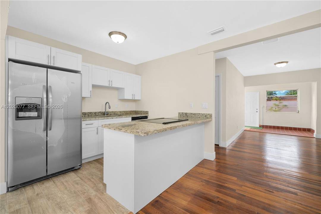 Charming duplex home in an up and coming neighborhood with a beautiful yard and a huge mango tree.