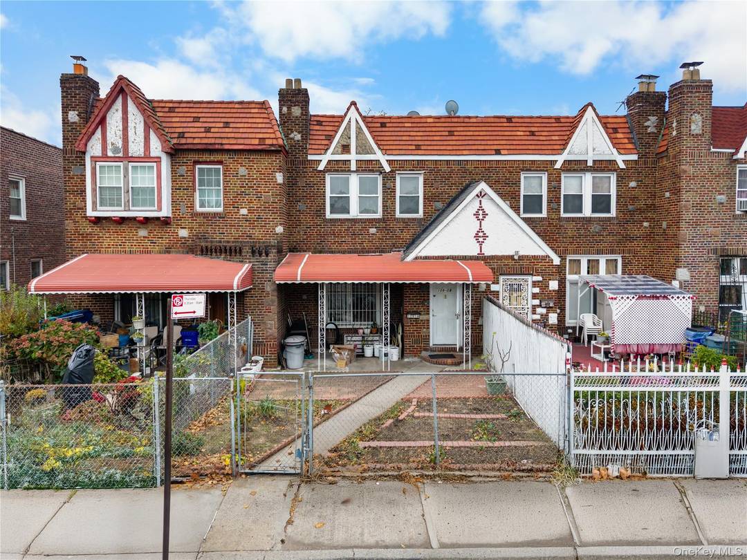 Charming, attached brick Tudor style single family home located in the heart of Queens Village.