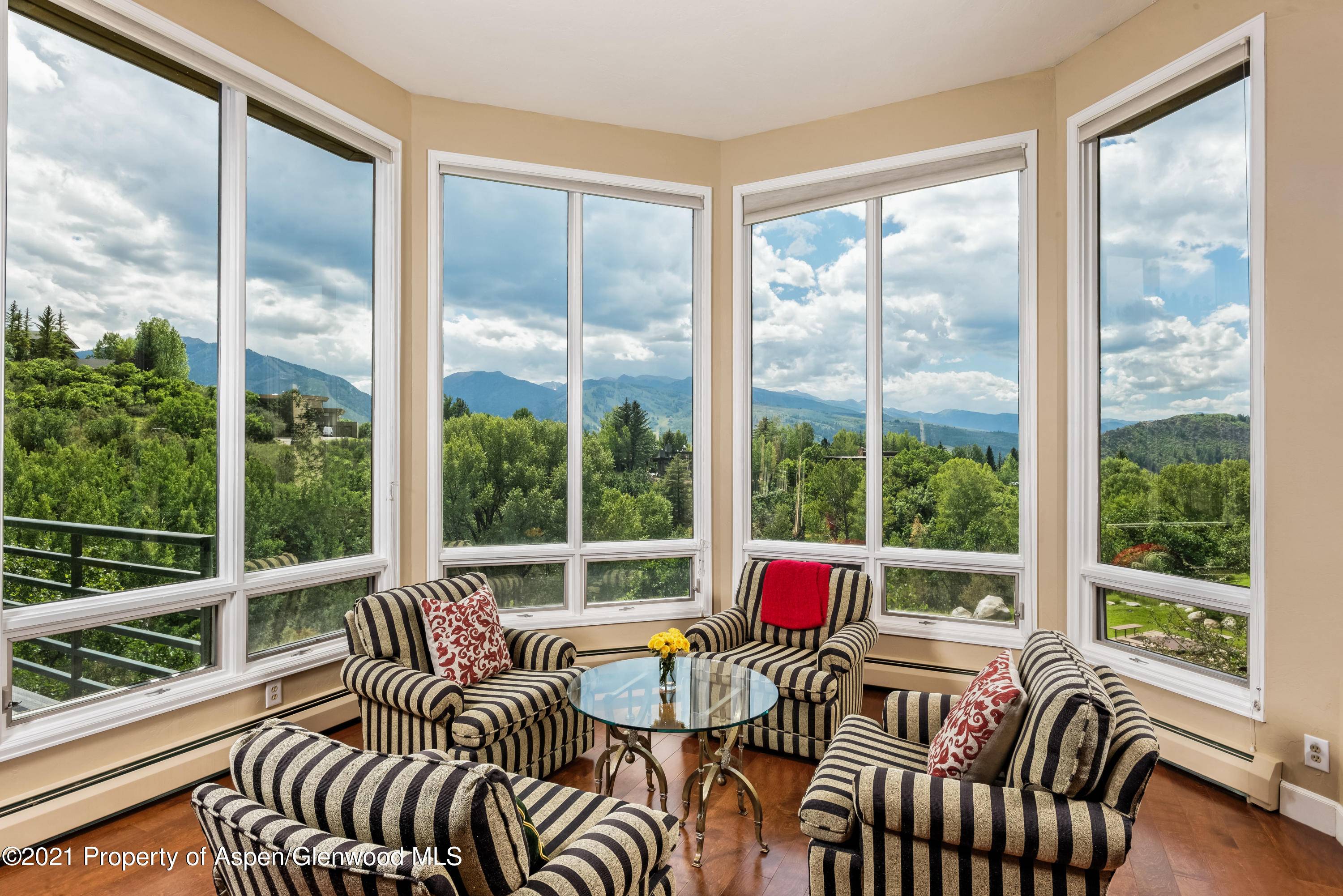 This homey, nestled retreat is bright and light with striking views from the open and inviting living, dining, and kitchen spaces.