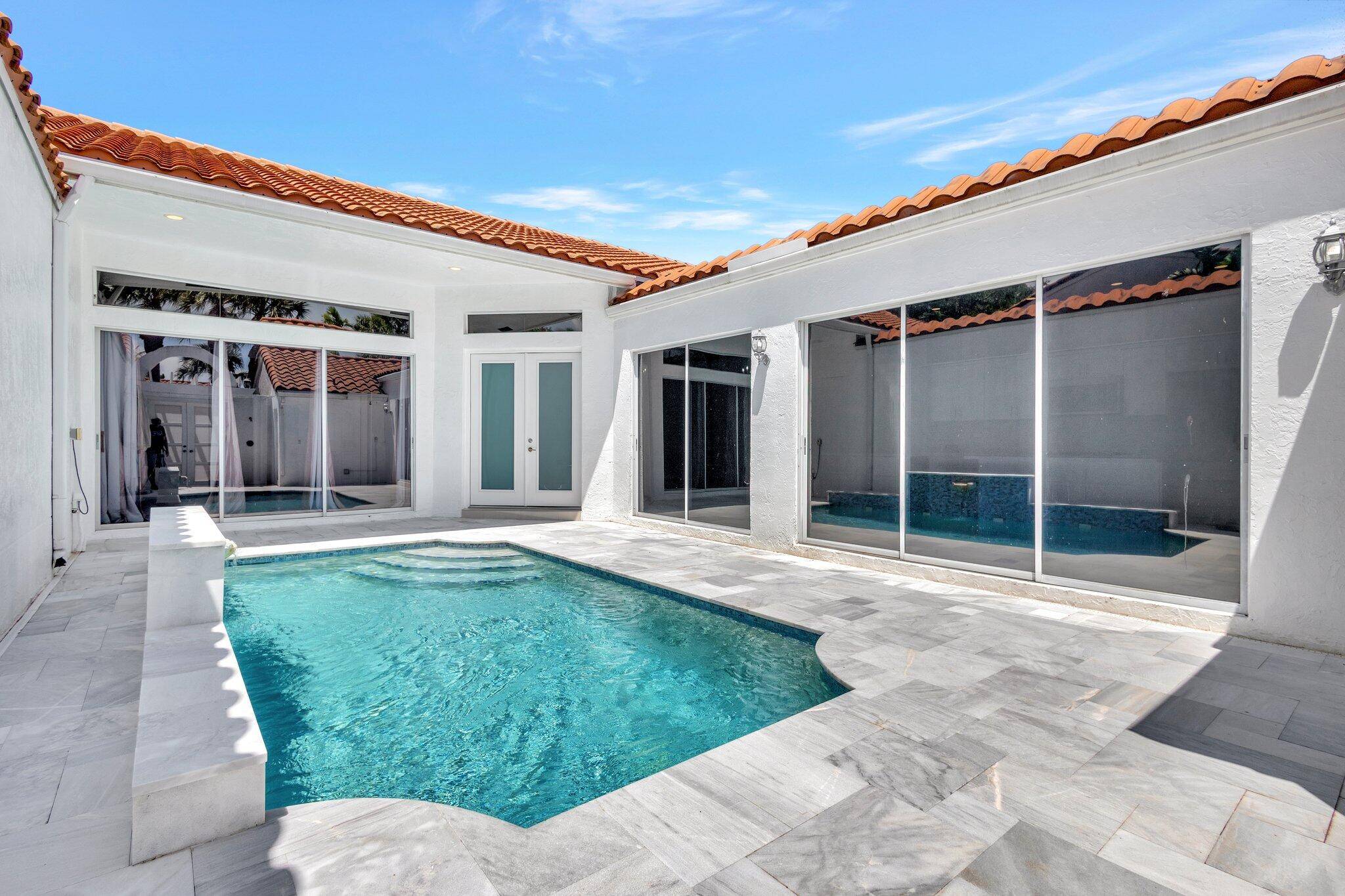 Enjoy a private, stylish, and low maintenance lifestyle in this beautifully updated 3BR 2BA villa with pool in the gated Boca Country Club.