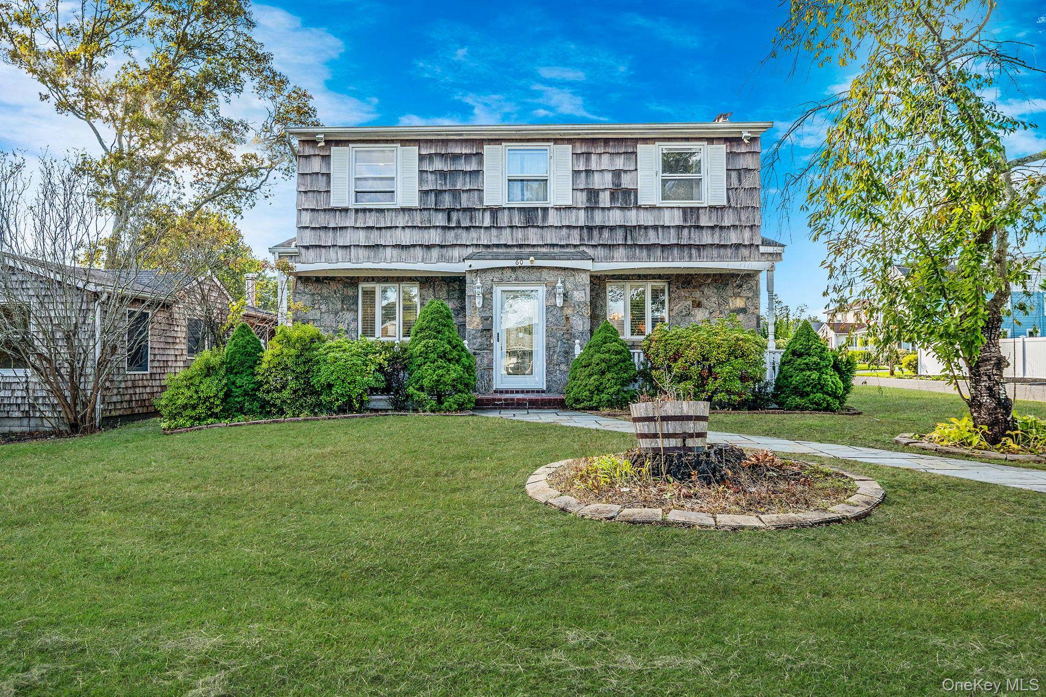 Welcome to 60 Lake Shore Drive a home that feels straight out of a storybook, where warmth, and space come together on one of Patchogue s most picturesque lakefront streets ...