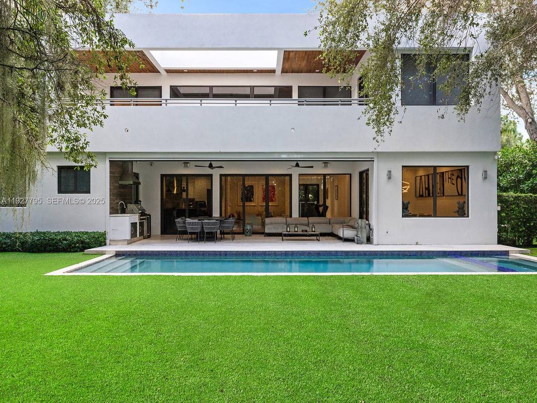 Discover refined Tropical Modern living in this ultra private North Grove home, set on a nearly 12, 000 SF gated lot and elevated 19 feet on coral ridge.