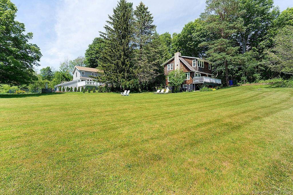Pristine barn style home on scenic dirt road with stream and small ponds.