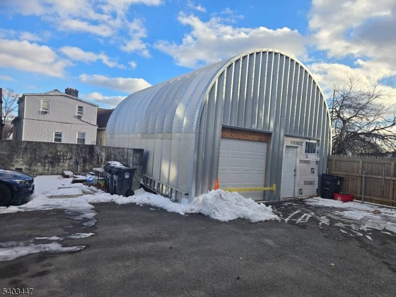 Three family with a walkout finished basement in North Newark, with a large garage warehouse in the rear.
