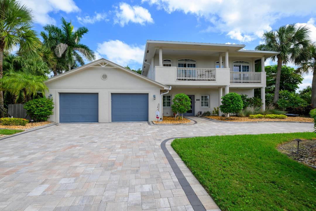 Unique custom craftsmanship in this beautiful Zen island home with water views of the Intracoastal.