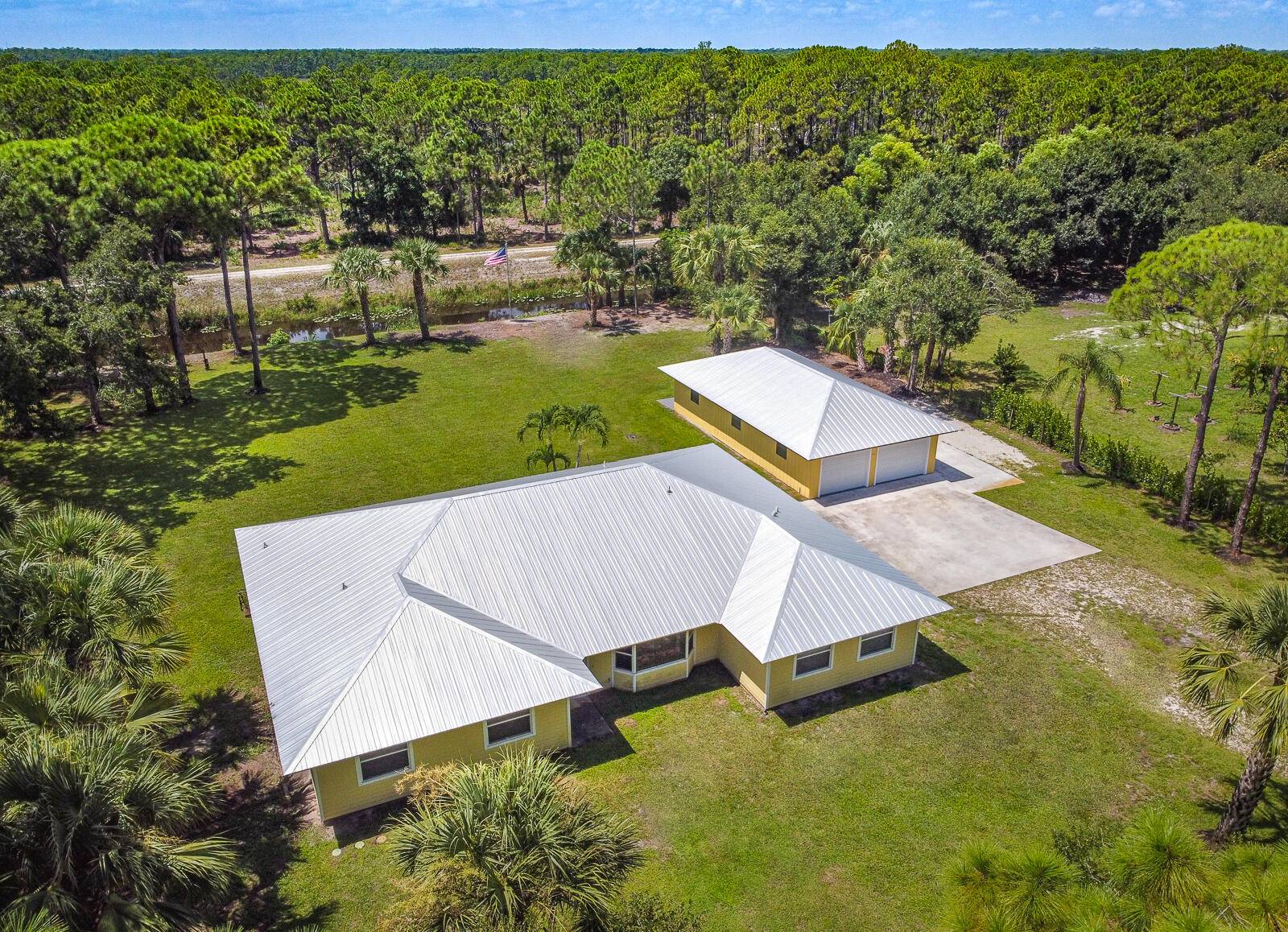 This 4BR 3BA home with a detached 24'x45' garage is the perfect project home situated on one of the nicest properties in Palm Beach Country Estates a RARE 1.