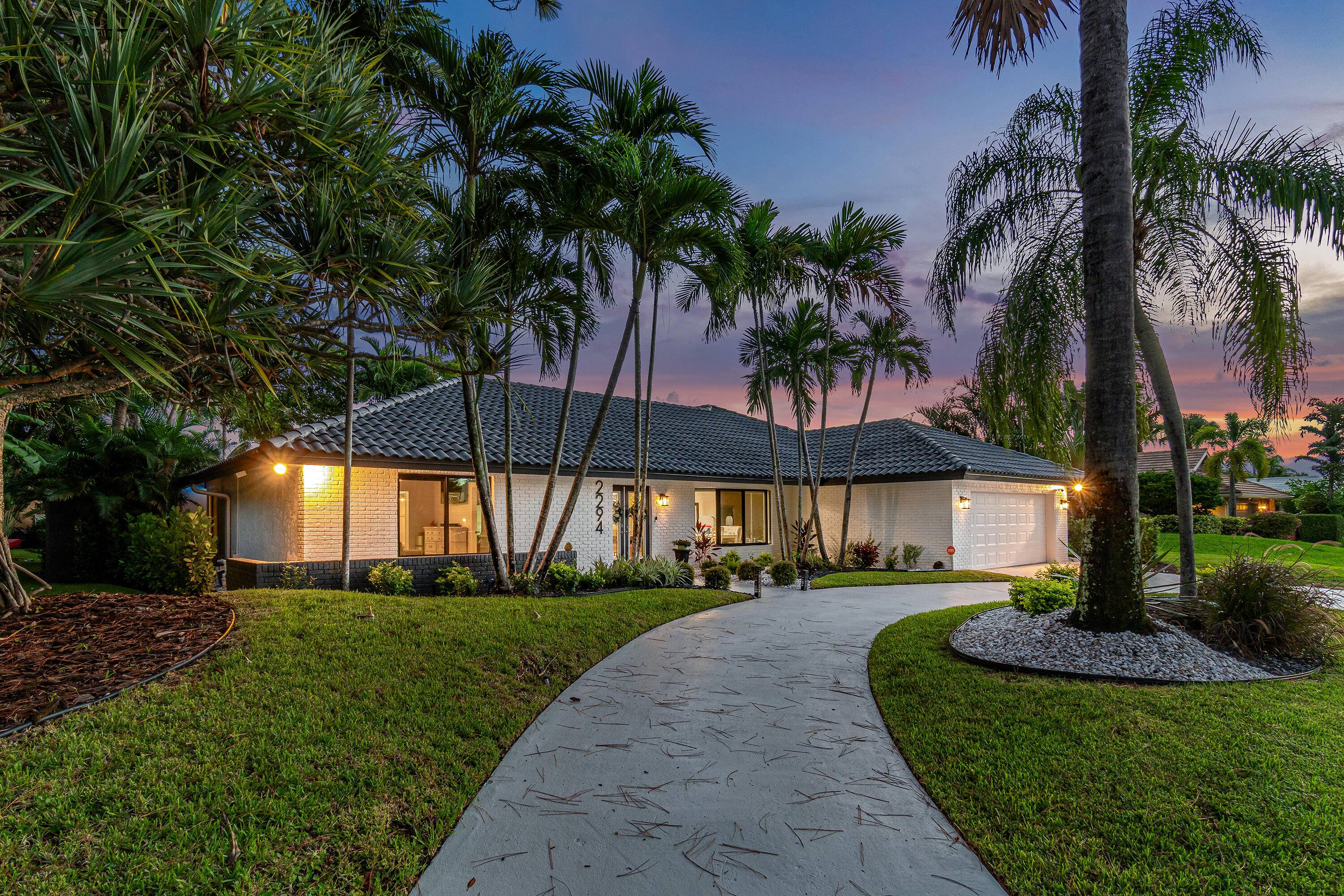 Discover elegance in this exquisitely renovated lakefront estate, perfectly positioned on an expansive corner lot within the esteemed Deer Creek Country Club.