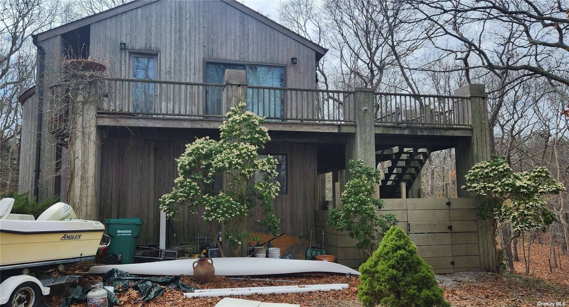 This unique 4 bedroom, 4 bathroom upside down house in East Hampton offers bedrooms on the first floor and a living area on the second floor.