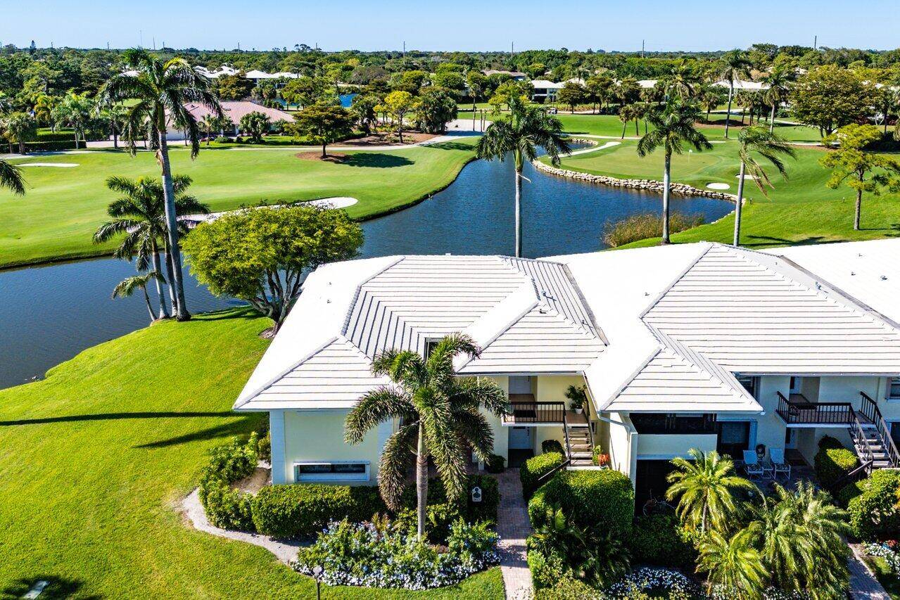 Welcome to this perfectly situated 2 bedroom, 2 bathroom first floor corner residence with panoramic views of the serene lake and golf course located in Bobwhite A.