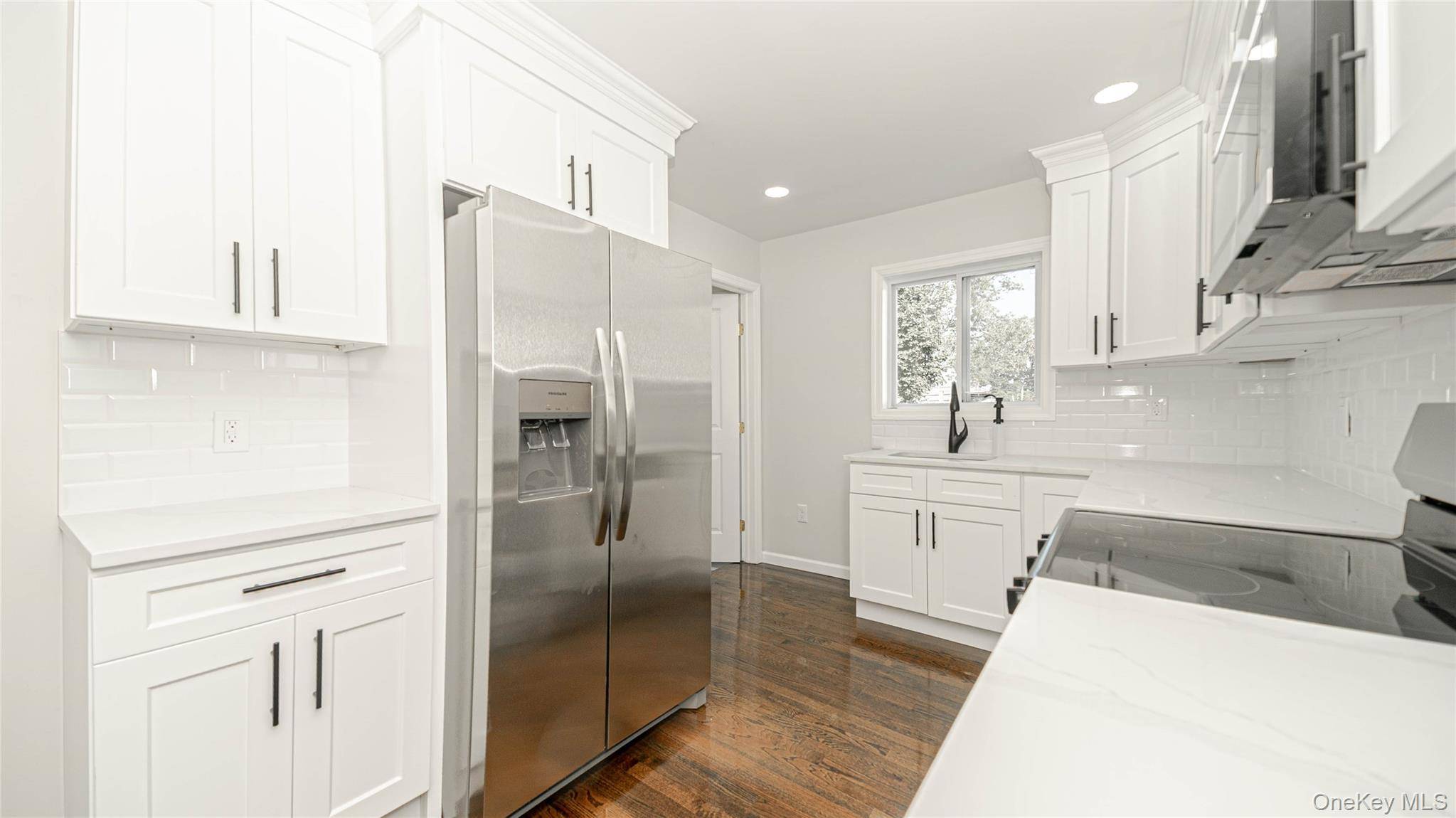 Welcome to this beautifully renovated Dormer Cape in the heart of Bay Shore !