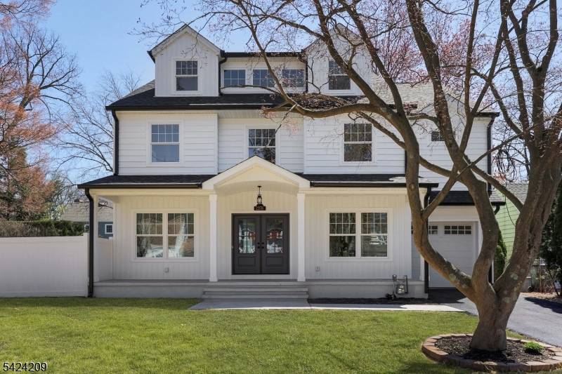 Nestled on a tree lined street, this stunning custom home sits on an oversized lot and offers nearly 4, 300 sq ft of beautifully designed living space.