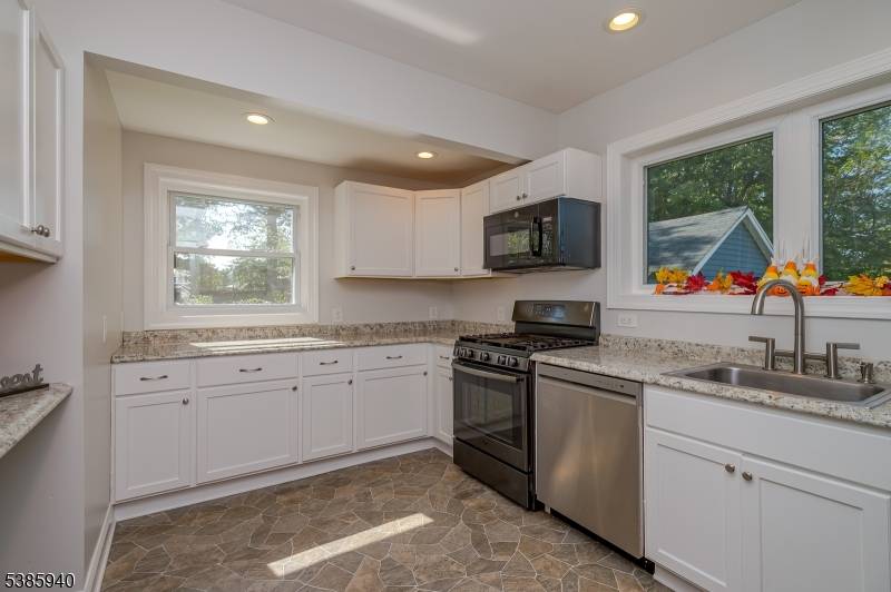 Completely Remodeled Colonial boasts beautiful Newer Kitchen with SS appliances, Newer Bath Windows.