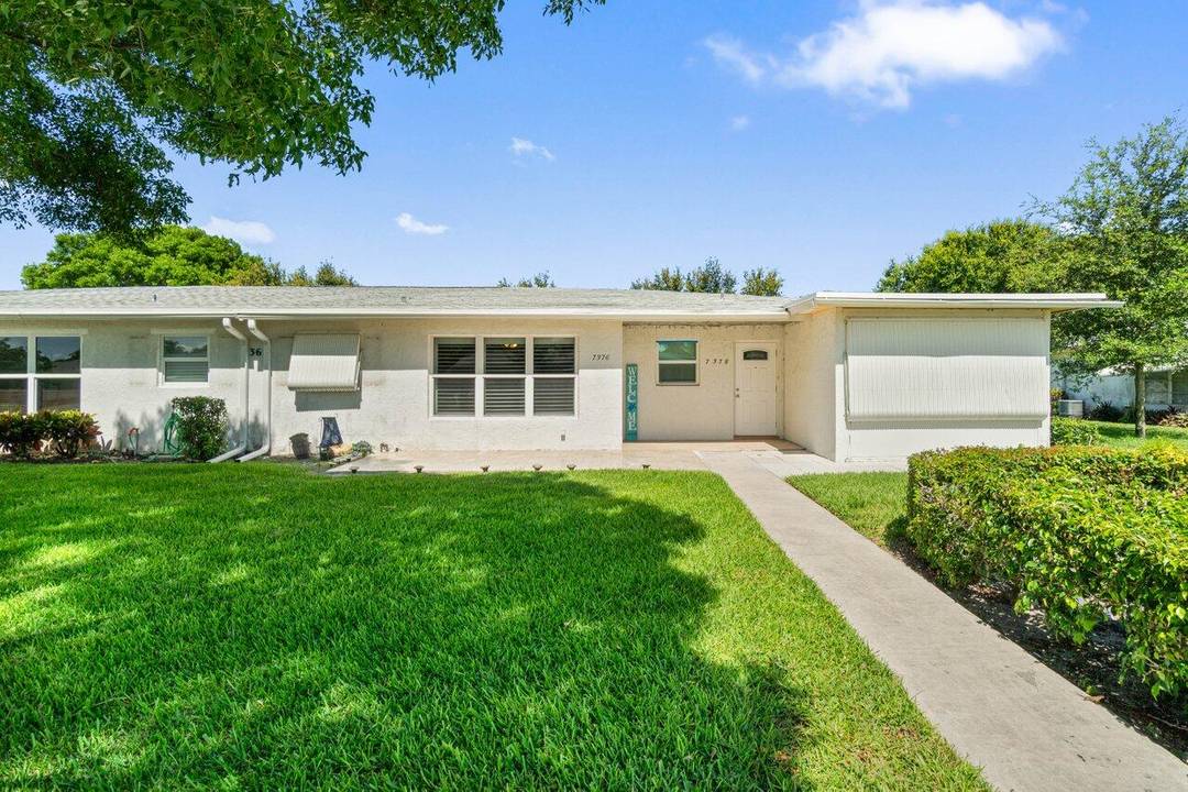 Welcome Home ! This beautifully tiled condo features impact windows and doors, plus a screened entry door to let in cool breezes.