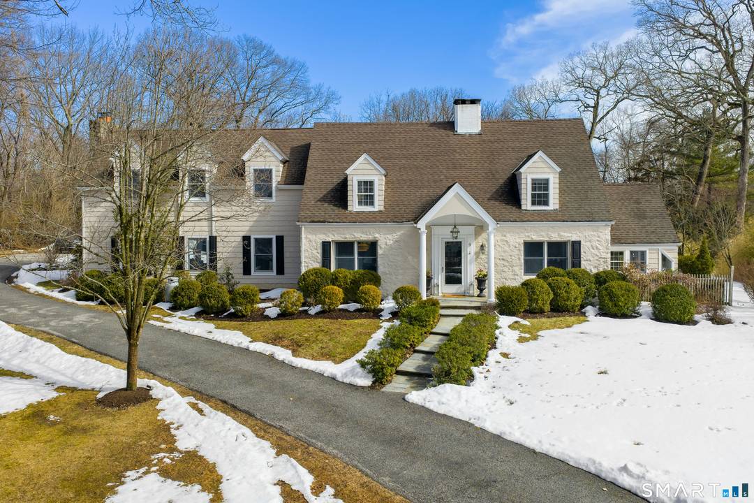 Located on a quiet cul de sac in Darien's sought after Ox Ridge School district, this inviting 4 bedroom Cape offers timeless character, privacy, and versatile living.