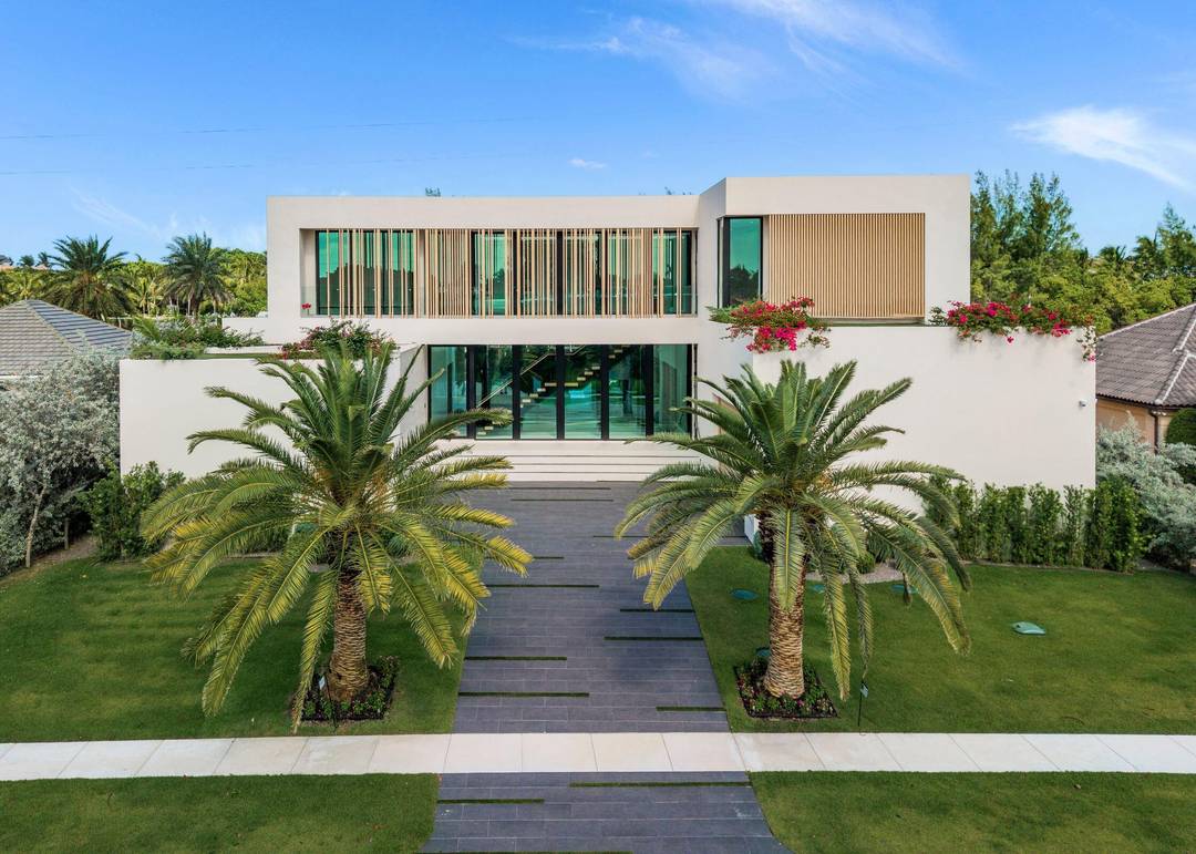 Showcasing refined modern architecture and rich natural materials, this exceptional six bedroom custom residence by Ocean Blue Custom Homes reflects understated sophistication.