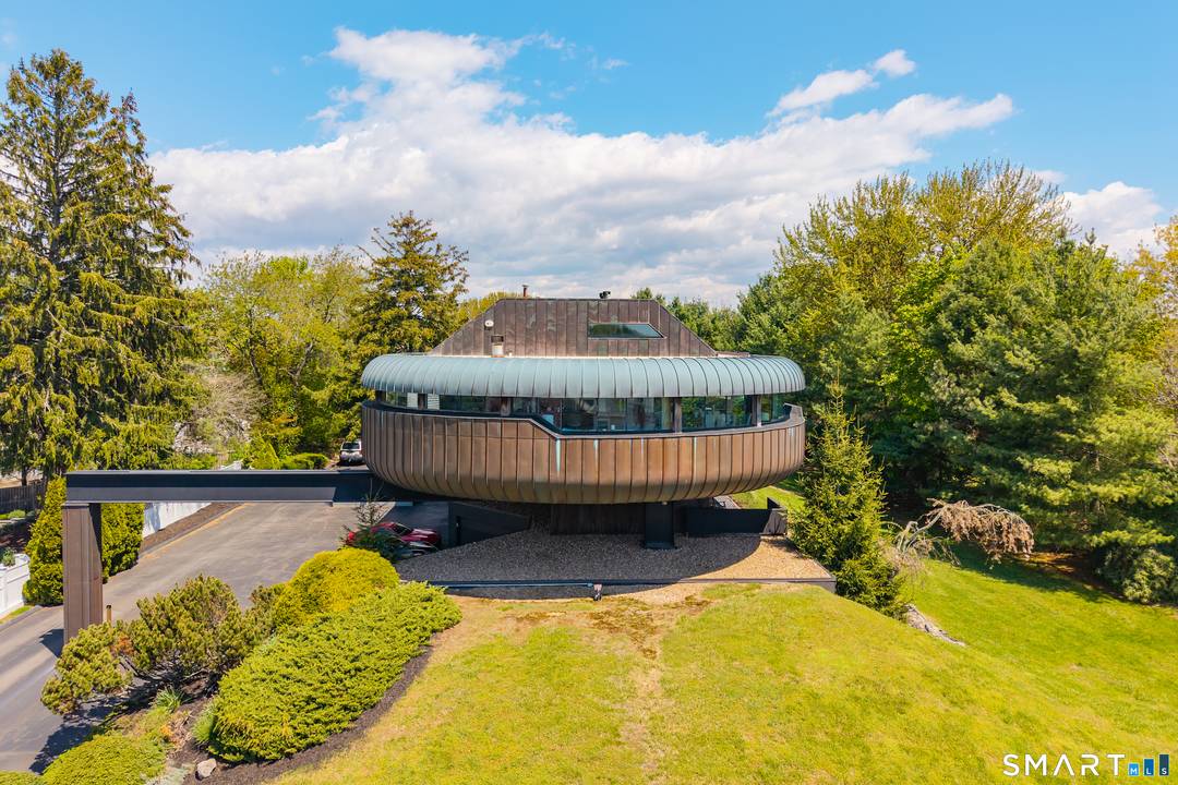 A rare opportunity to own one of downtown Guilford's most iconic residences, often referred to as The Spaceship, masterfully designed by architect Wilfred Armster.