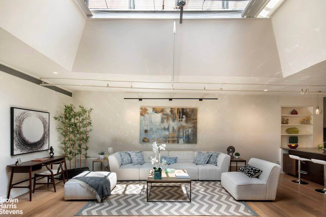 Experience the epitome of SoHo living in this airy and dramatic full floor loft situated on Mercer Street, one of the neighborhood's most sought after blocks.