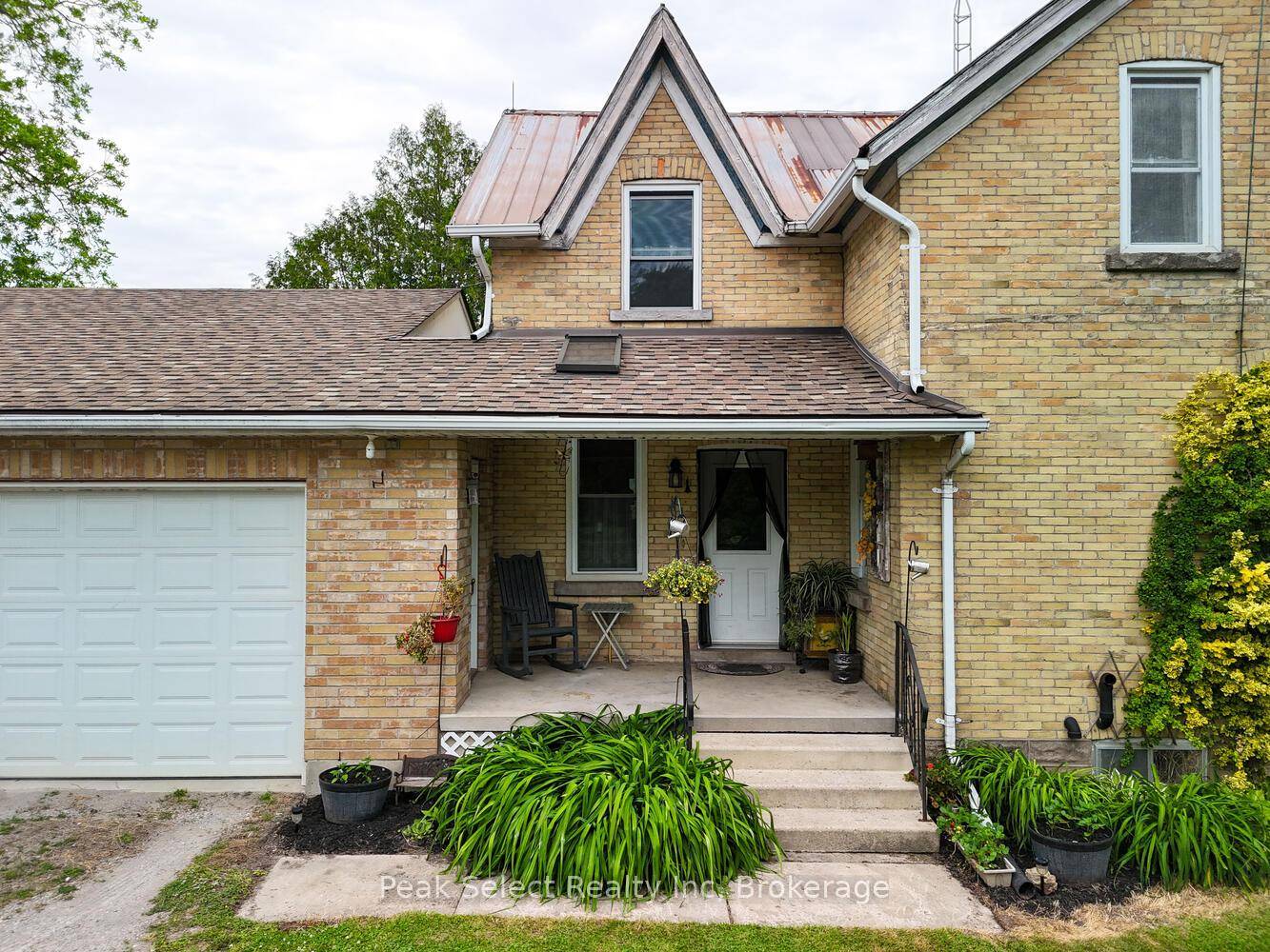 Welcome to this classic yellow brick century farmhouse nestled on a generous 121 x 239 lot, offering exceptional privacy and rural charm.