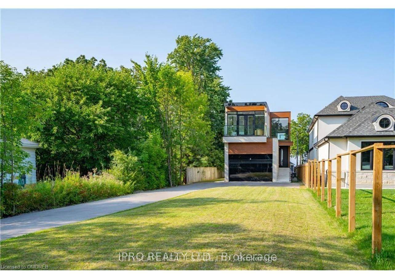 Welcome to 6 Campview Road a truly exceptional waterfront estate offering luxury, privacy, and rare direct access to the shores of Lake Ontario.