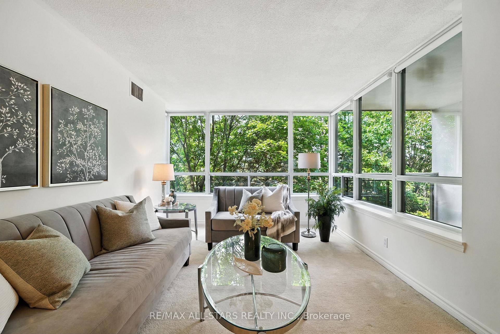 Freshly painted open concept 2 bedroom 2 bathroom suite with walls of windows showcasing spectacular treed views.