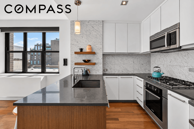 Apartment 5A is an oversized, south facing studio with over 600 square feet and eight windows framing open sky and the Domino Towers.