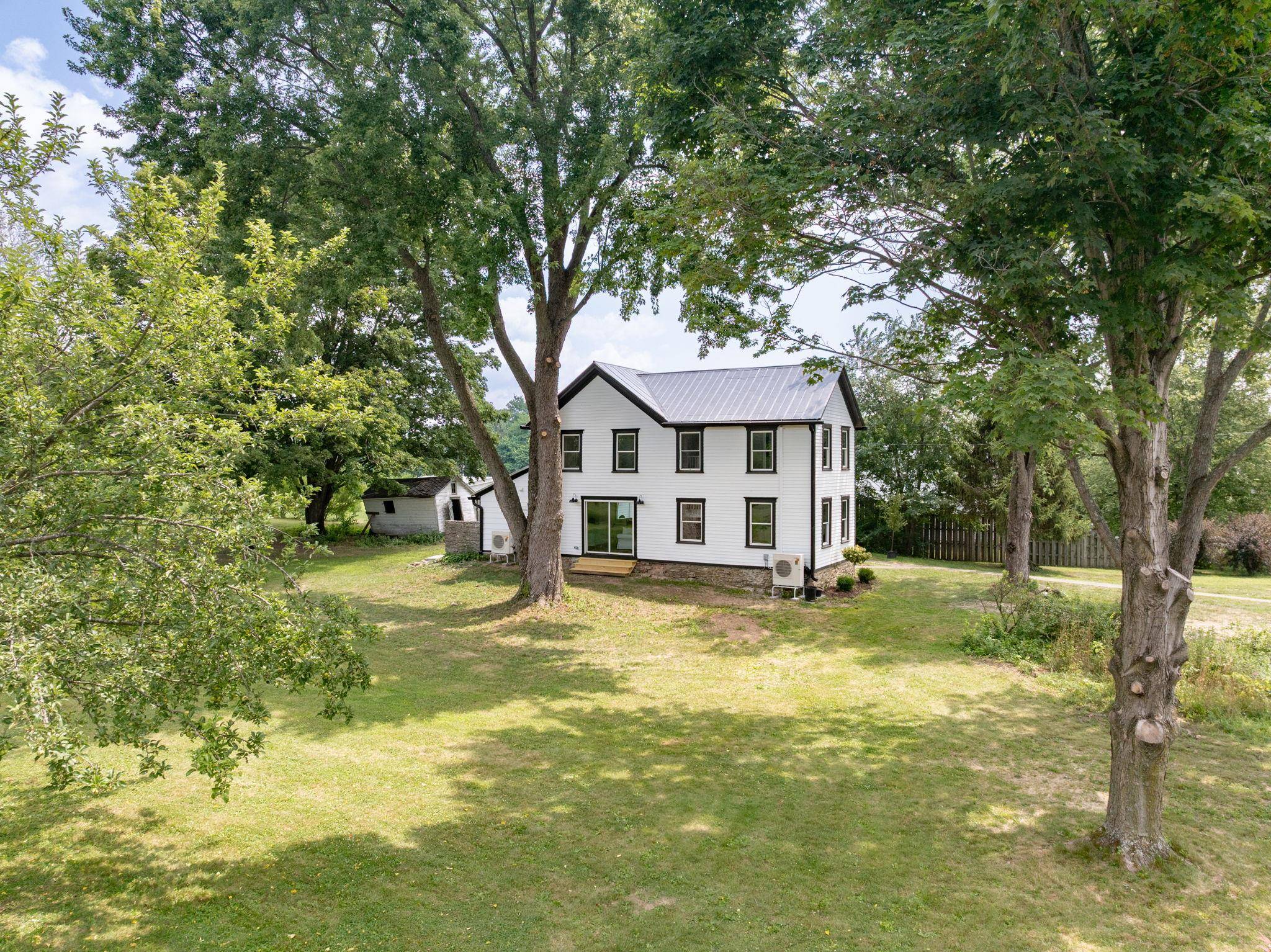 This lovingly restored 1900 farmhouse offers the rare combination of historic character, thoughtful updates, and a setting that ensures lasting privacy.