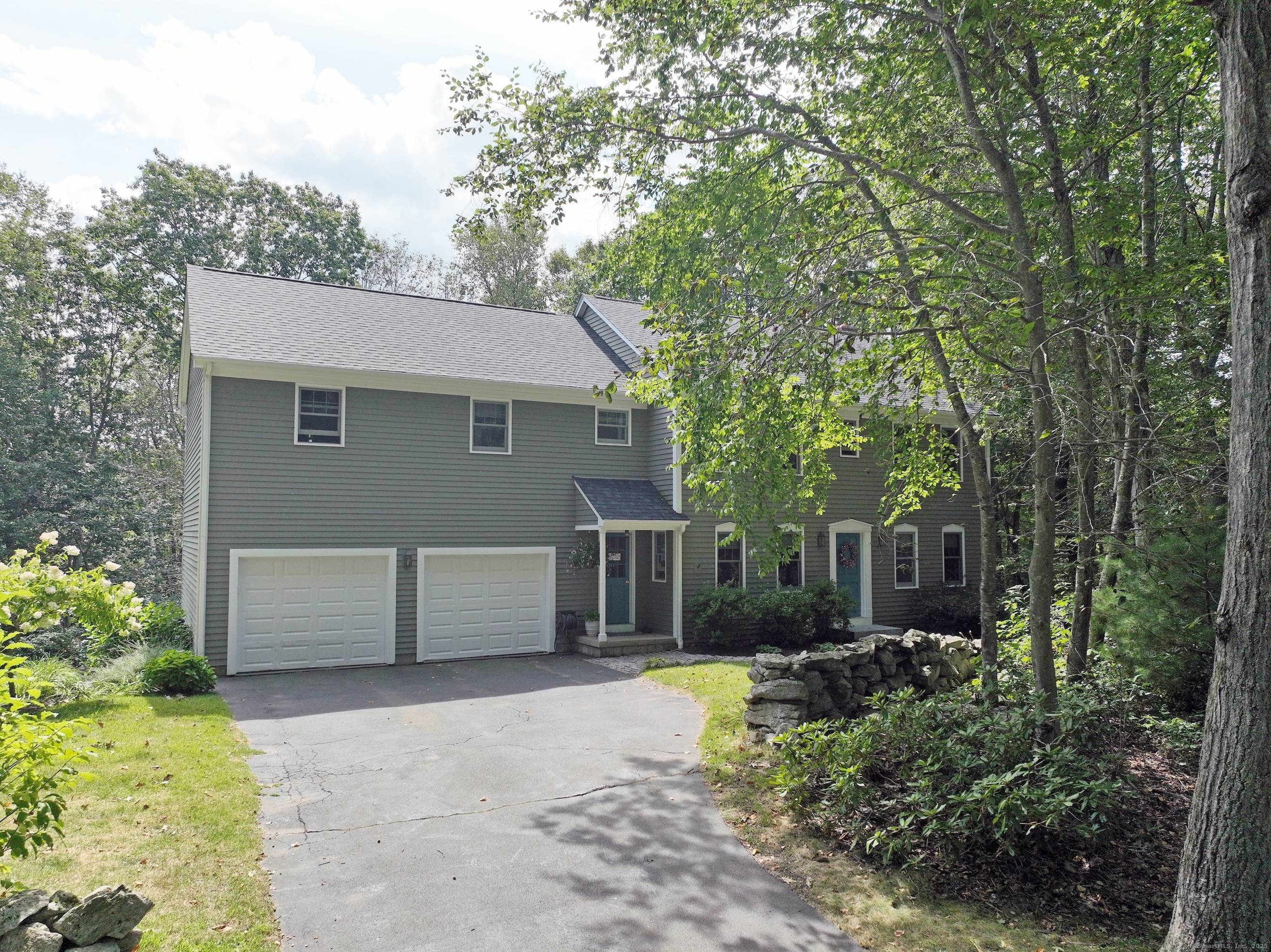 Nestled at the beginning of a quiet cul de sac and surrounded by mature trees and classic stone walls, this beautifully maintained 3 bedroom, 2.