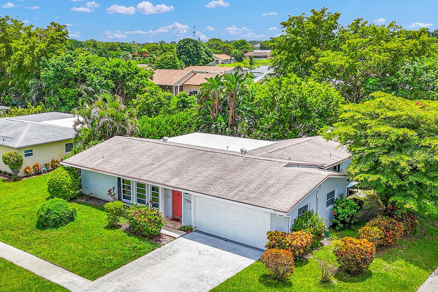 RENOVATED home with a 2 CAR GARAGE, upgraded kitchen, polished porcelain tile floors that connect every room to the private screened in porch with ceiling fan mounted TV.