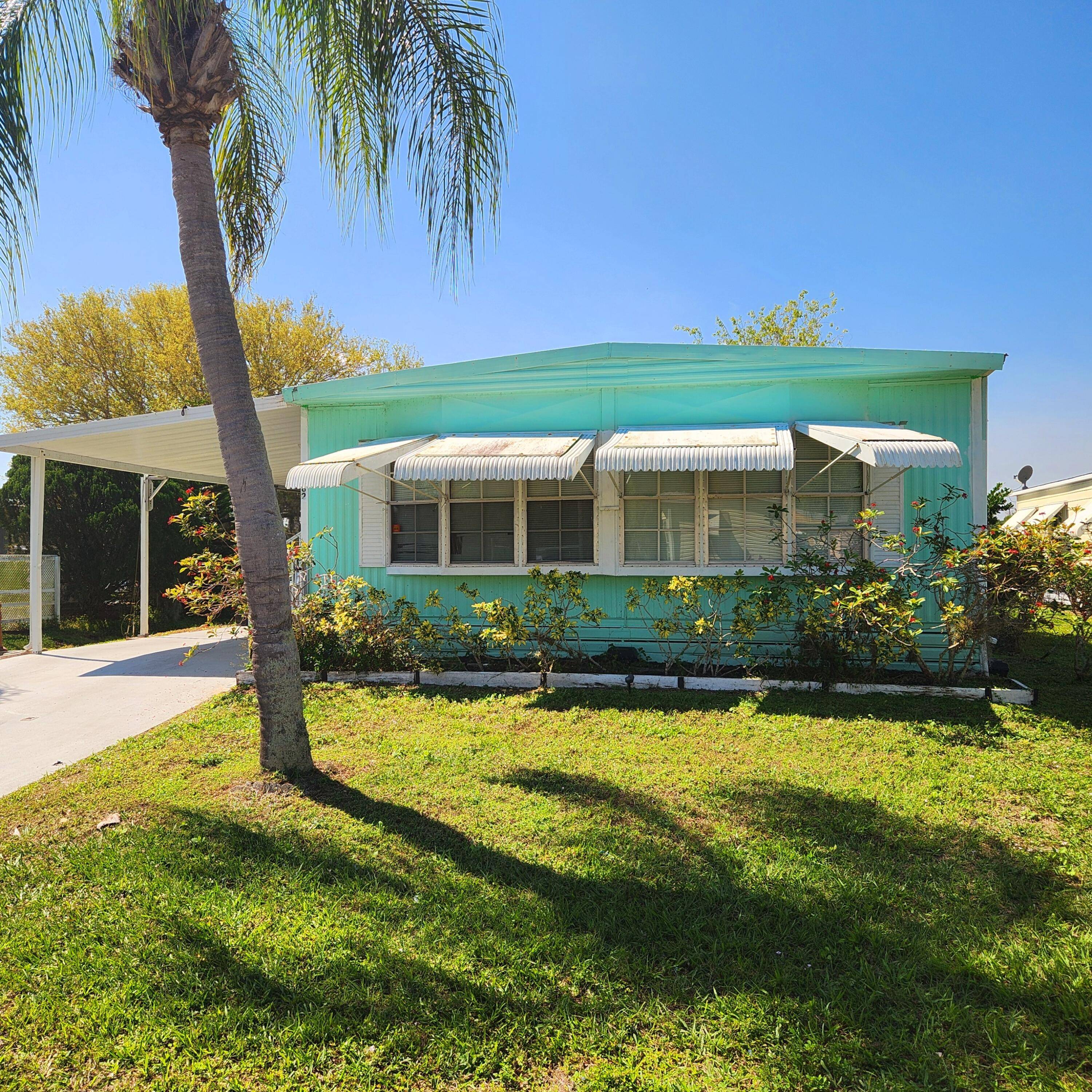 One month of free lot rent for this lakeside handyman's retreat in the vibrant 55 community of Spanish Lakes Golf Village.