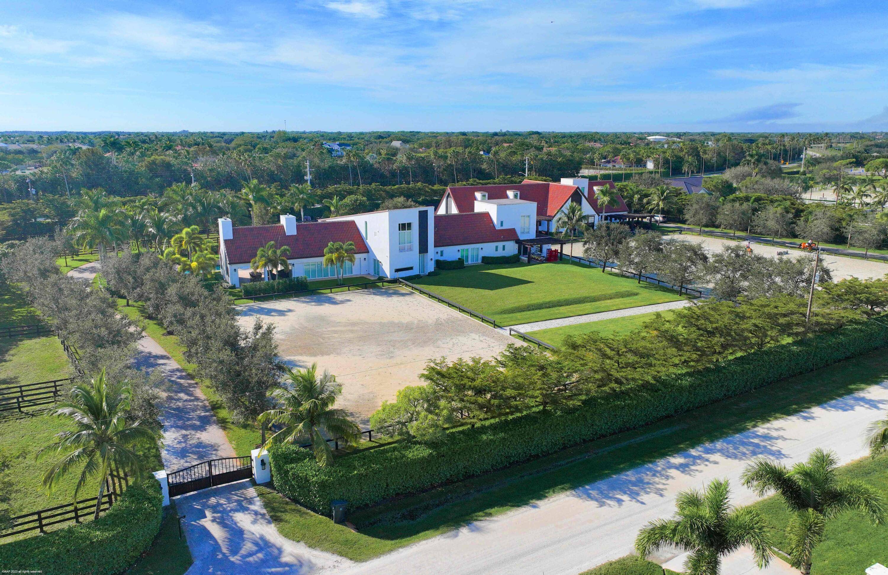 This premier gated equestrian estate in Saddle Trail is available for PRIVATE seasonal rental and offers an exceptional location just one mile from Wellington International, accessible via maintained bridle paths.