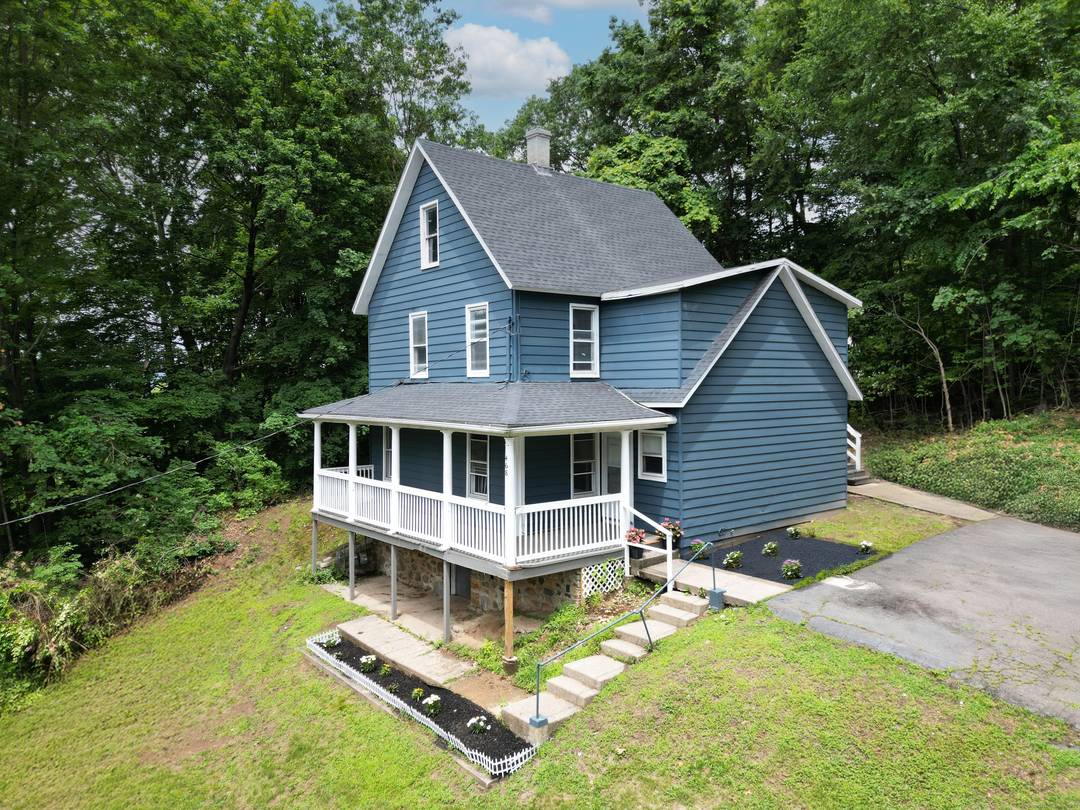 Impressive two family on more than a half acre, perched at the end of a private paved driveway !