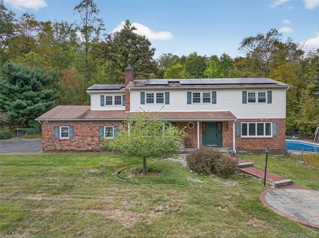 Nestled on just under an acre of lush, private grounds, this 5 bedroom, 3.