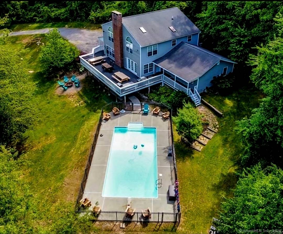 Nestled at 5 Bittersweet Drive in Gales Ferry, CT, this impressive property showcasing 4 5 bedrooms, two spacious primary suites, 3 full baths, a heated inground saltwater pool, outdoor hot ...