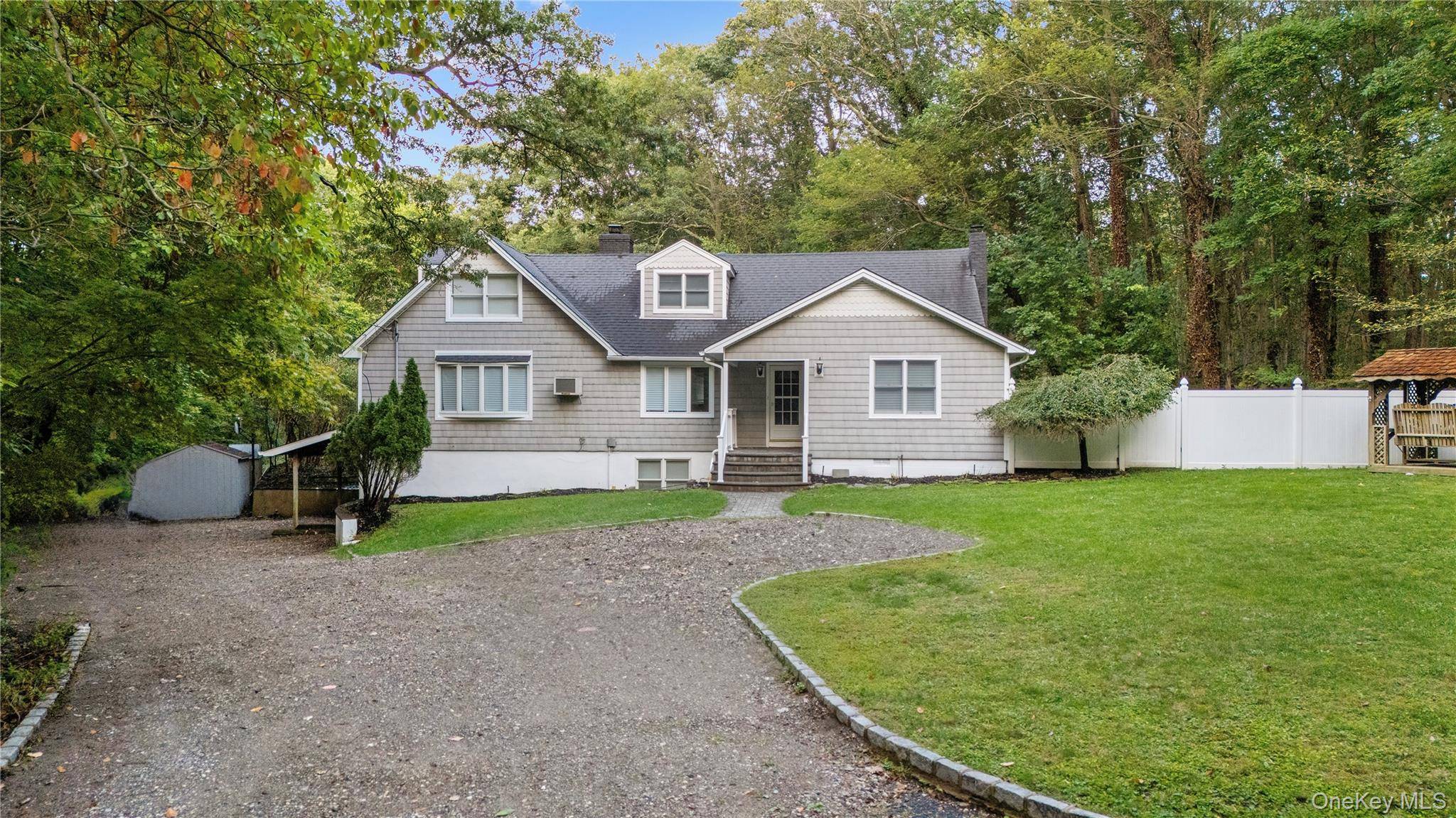 Welcome to 57 Eastwood Rd, Miller Place a fully renovated home tucked away in a private wooded setting, featuring a sparkling pool with a brand new lining and filters.