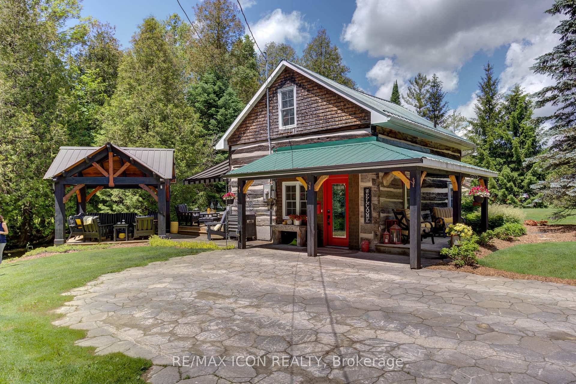 Welcome to this stunning century old log cabin nestled on a serene creekside setting, offering a perfect blend of rustic charm and modern luxury.