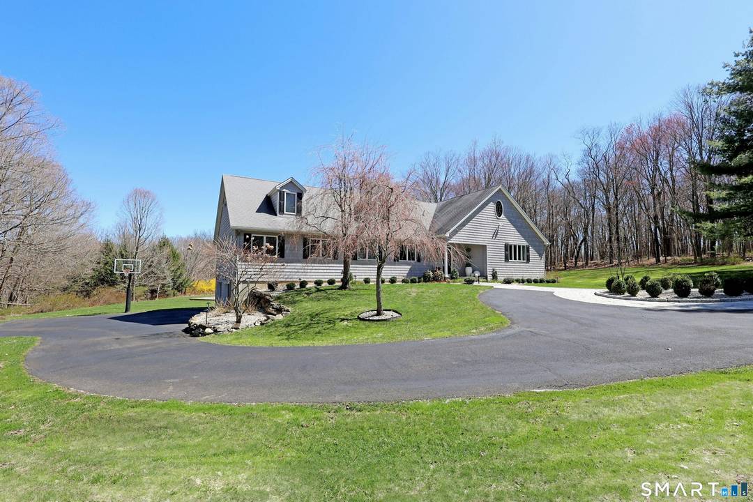 Impeccable shingle style country cape on park like 2.