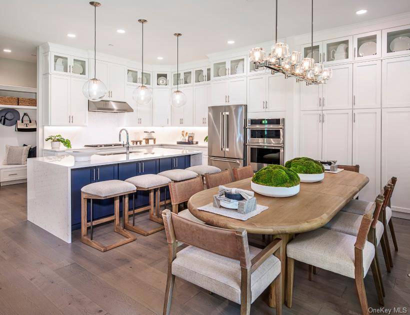 The striking two story foyer offers sweeping views of the great room just beyond.