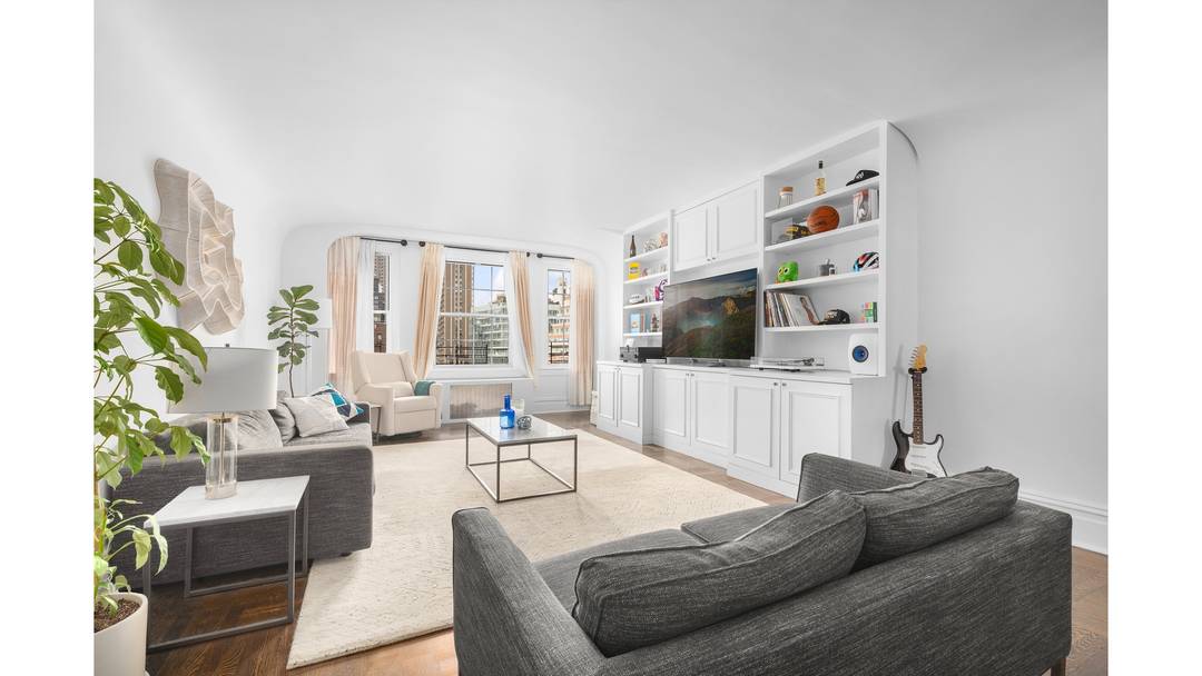 A gracious, oversized foyer welcomes you in, framed by iconic arched doorways that set the tone for the home's classic pre war charm.