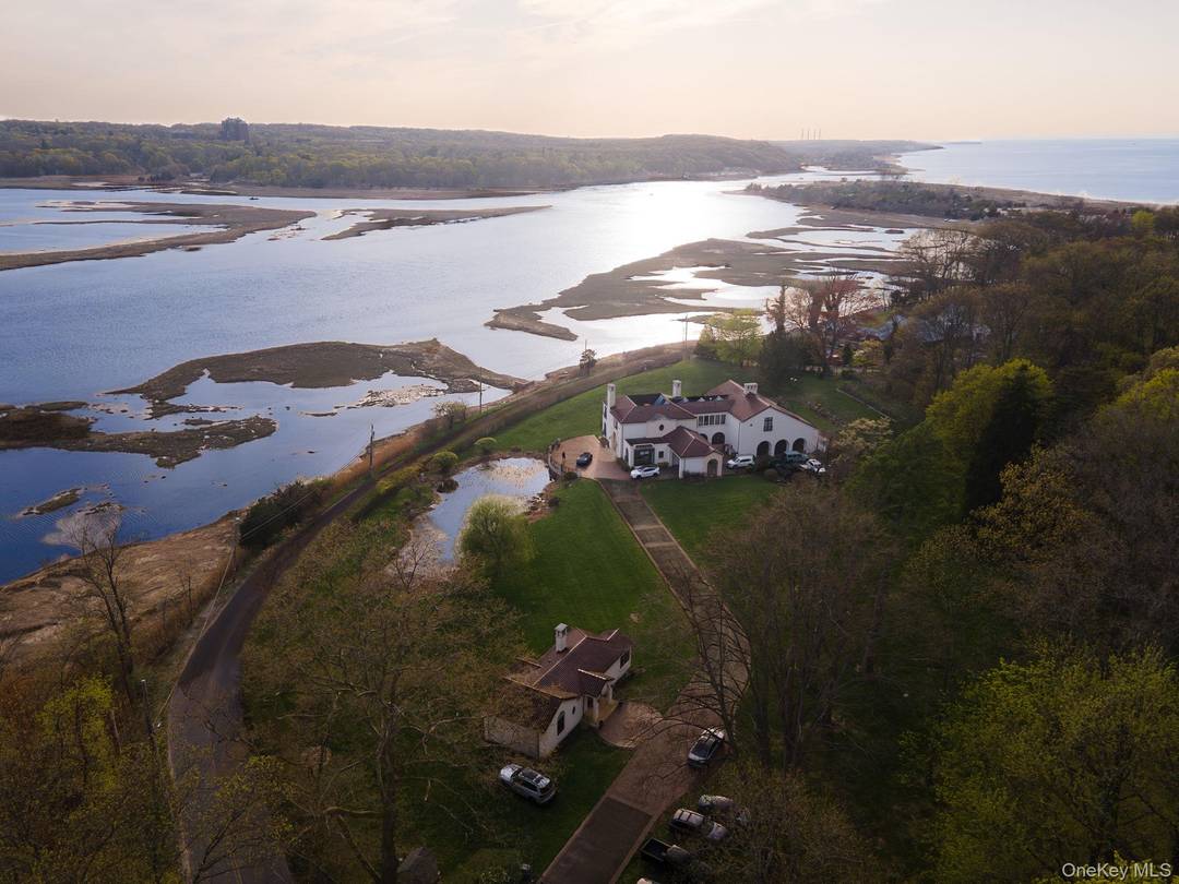 Experience timeless architecture and peaceful luxury in this Feng Shui inspired estate nestled within the prestigious Short Beach enclave of Nissequogue.