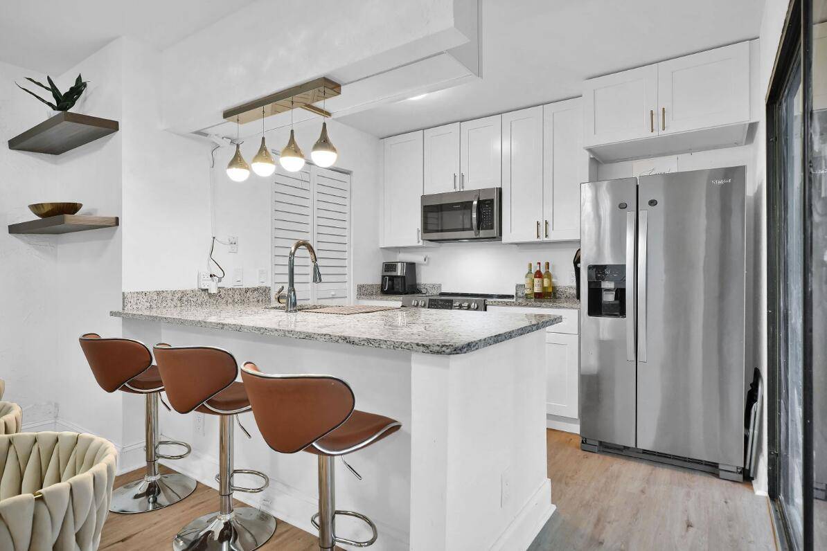 From the Moment You Step Into Your Private Courtyard Entrance ; This 3 BR 2 BA, Contemporary Corner Townhome Already Feels Like Home !