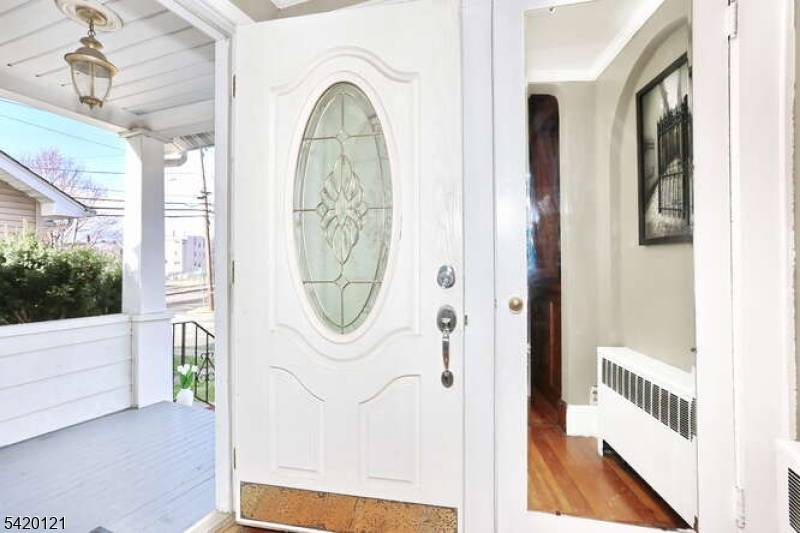 Nestled on a tree lined street in Hawthorne, this charming side hall colonial has gorgeous natural wood trim, ceiling beams and built ins throughout the dining and living room.